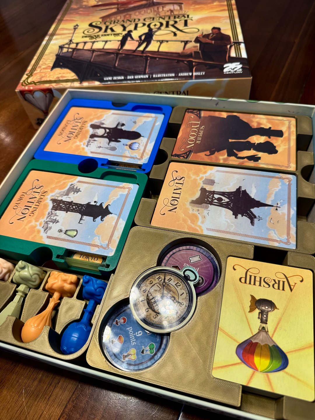 Grand Central Skyport Deluxe Organizer by KreativLayers, featuring compartments for game pieces and cards.