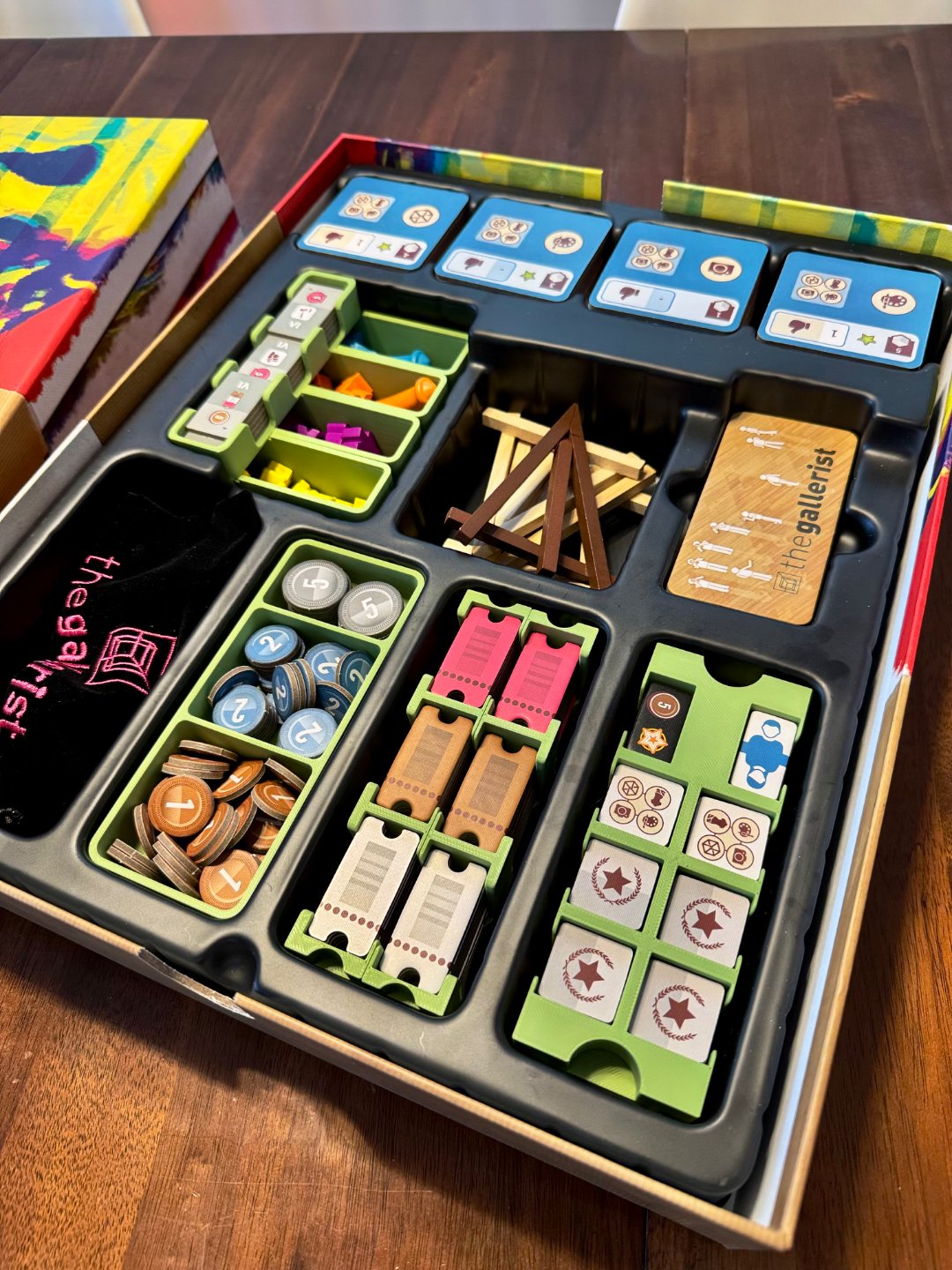 KreativLayers Gallerist Organizer for board game components with multiple compartments and a sleek design.