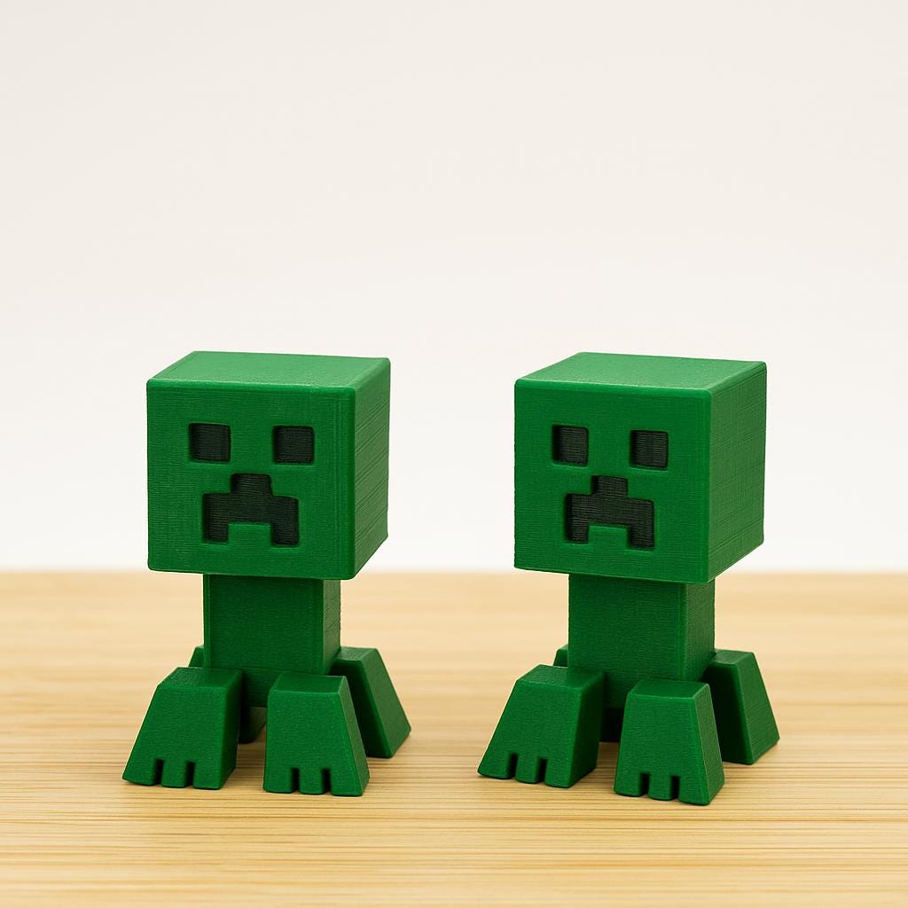 Pair of green 3D printed board game organizer figures on wooden surface, KreativLayers