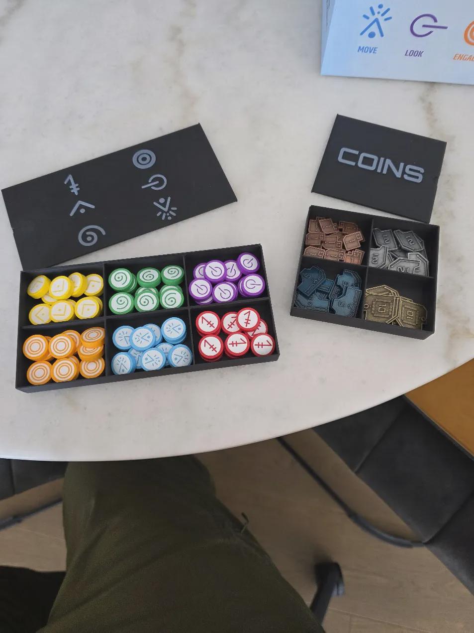 KreativLayers 3D printed board game organizer with colorful tokens and coin storage trays on table