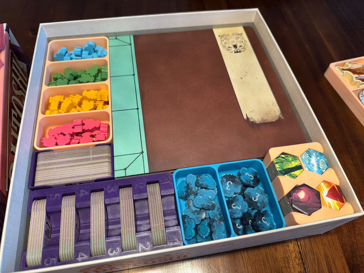 Daitoshi Board Game Organizer by KreativLayers, featuring multiple compartments and no lid for easy access to game pieces.