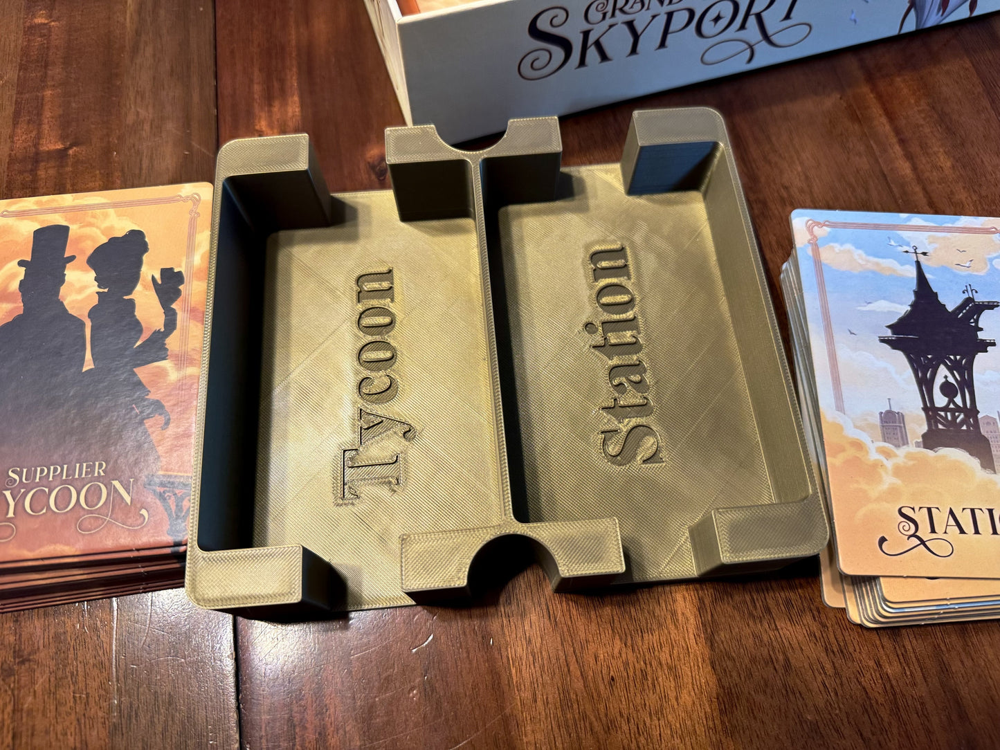 KreativLayers Grand Central Skyport Deluxe Insert, a board game organizer with multiple compartments and a sleek design.