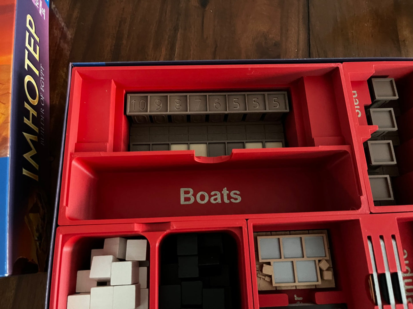 Imhotep Board Game Organizer by KreativLayers with upgraded components, showcasing compartments for game pieces and cards.