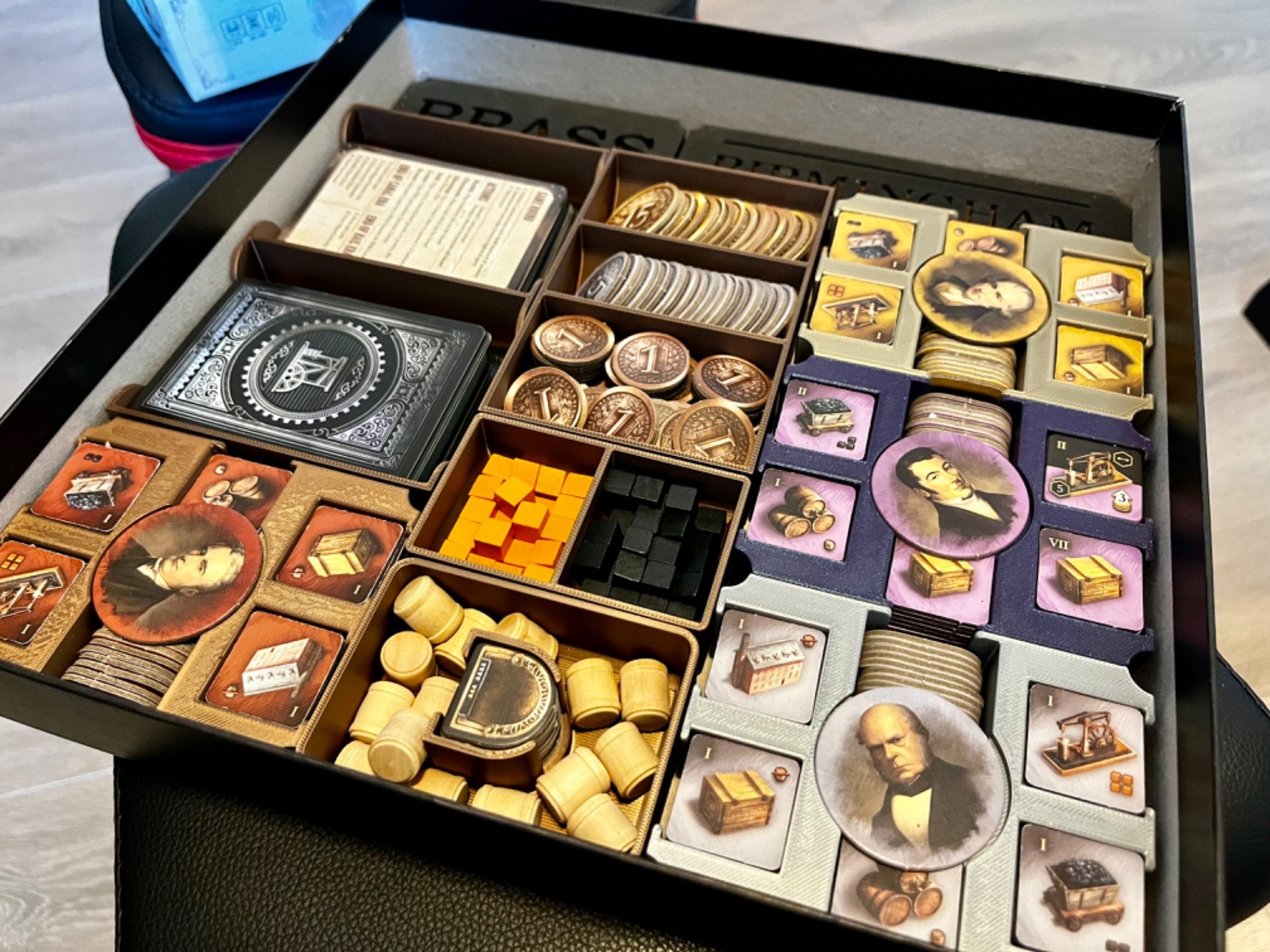 Brass Birmingham inserts by KreativLayers, showcasing a detailed board game organizer with compartments for game pieces.