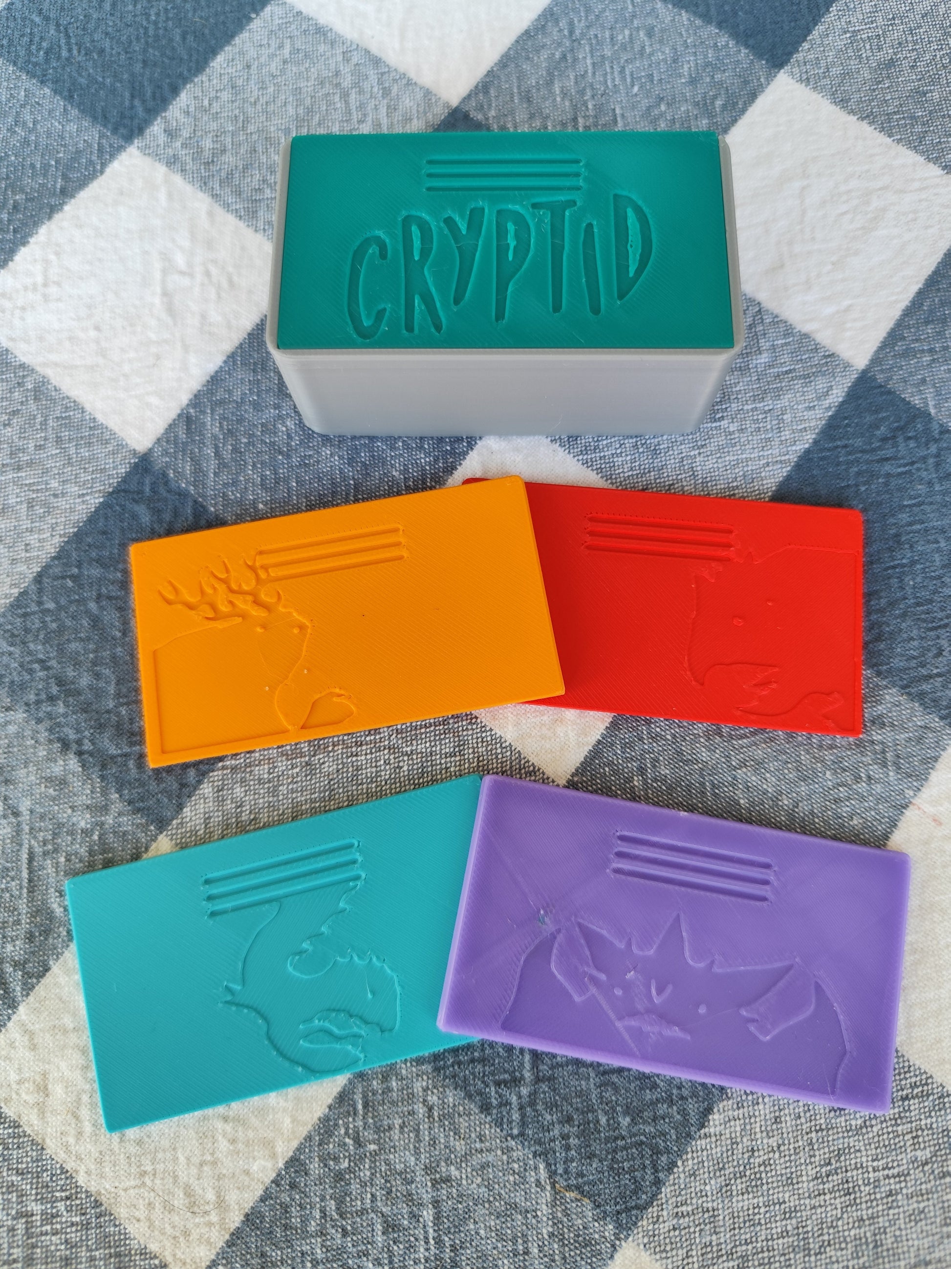 KreativLayers Cryptid INSERT board game organizer with compartments for cards and tokens, displayed on a wooden table.