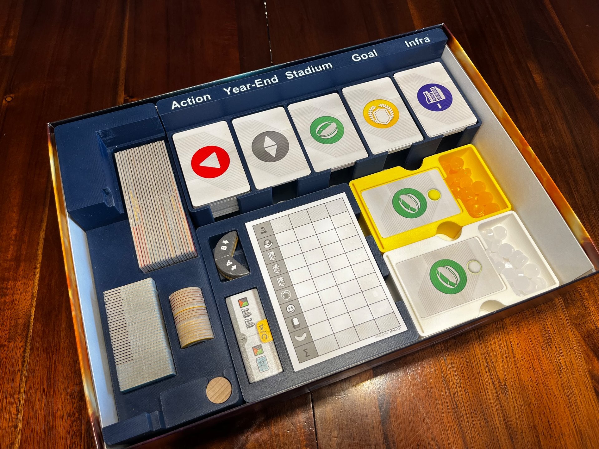 KreativLayers evacuation game organizer insert with compartments for game pieces and cards, shown in a neat arrangement.