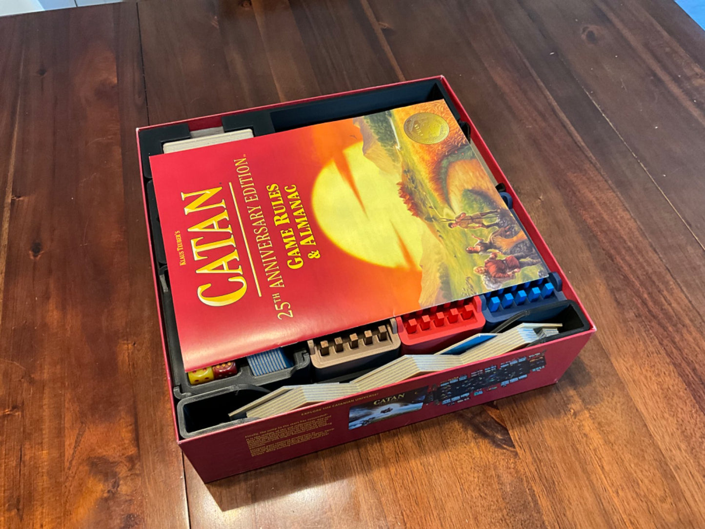 Catan 25th Anniversary Edition organizer by KreativLayers, featuring custom compartments for game components and cards.