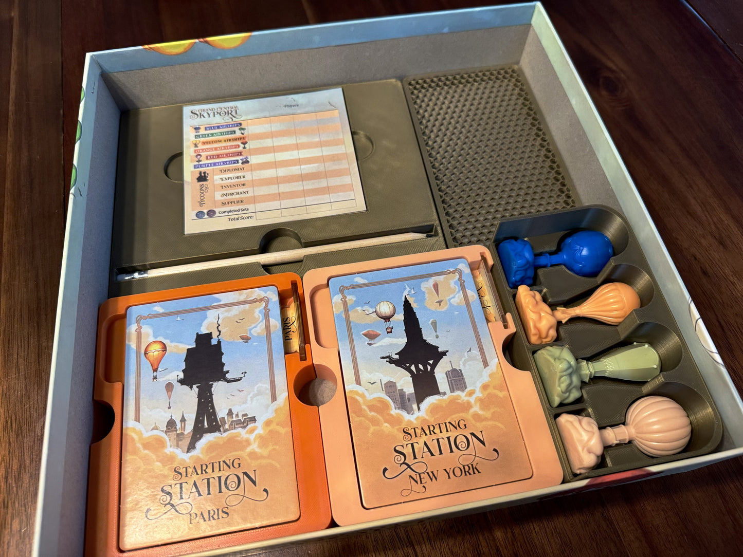 Grand Central Skyport Deluxe Board Game Organizer by KreativLayers with multiple compartments and a sleek design.