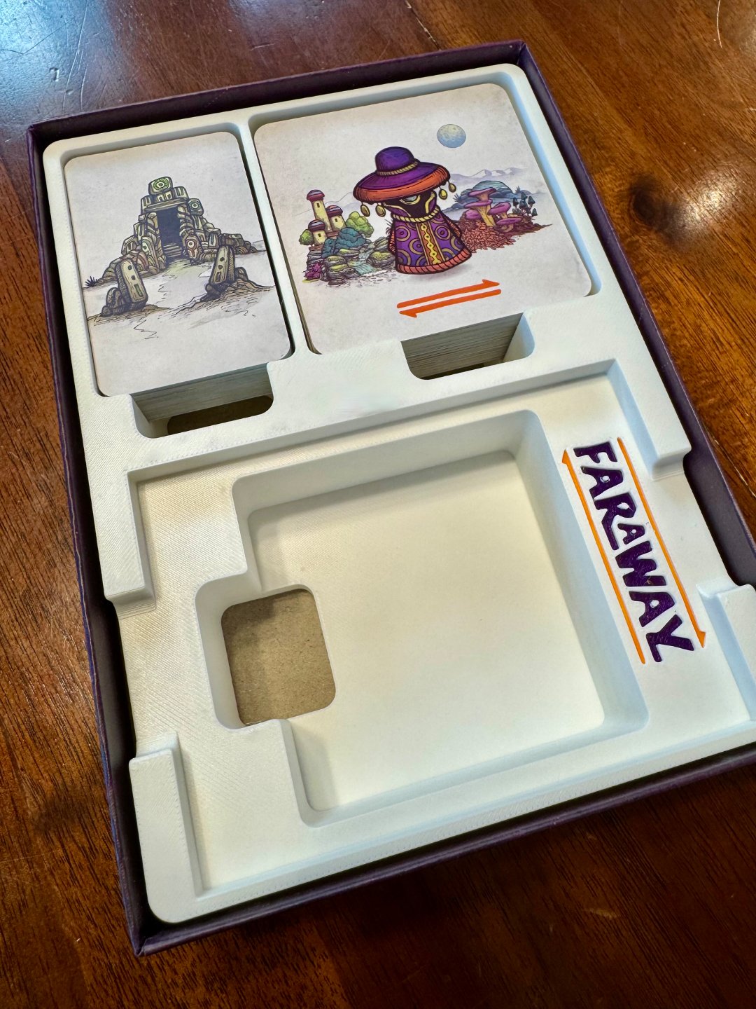KreativLayers Faraway Game Insert, a board game organizer with compartments for game pieces and cards, neatly arranged.