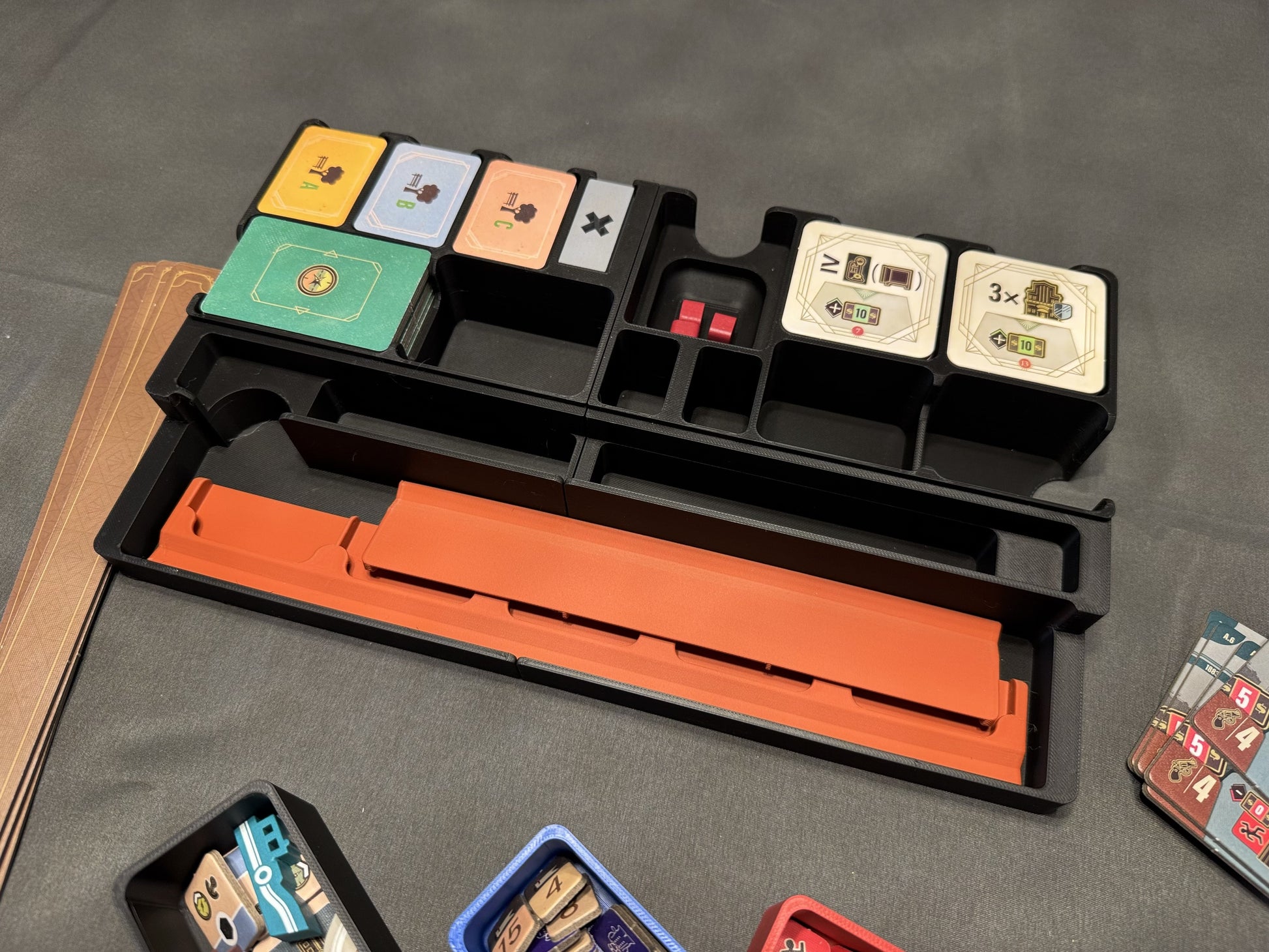 KreativLayers Speakeasy Board Game Organizer with compartments for cards, tokens, and game pieces.