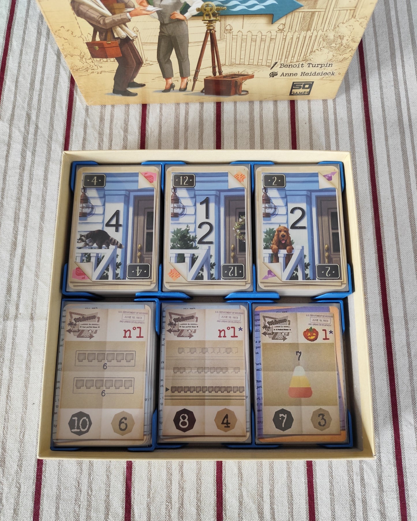 KreativLayers board game organizer for "Welcome To INSERT" with compartments for game components and cards.