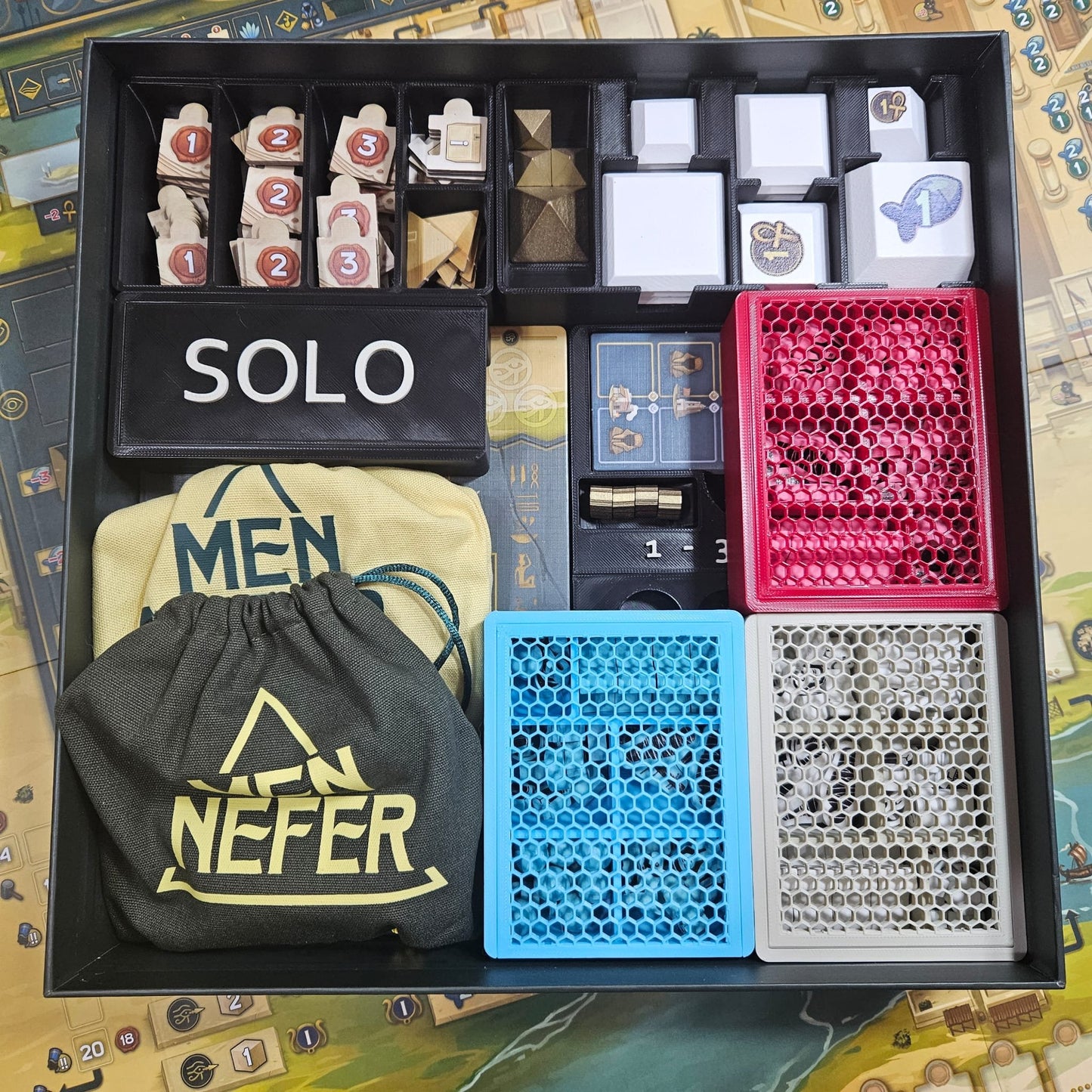 Men-Nefer Board Game Organizer by KreativLayers with compartments for game pieces and cards, featuring a sleek design.