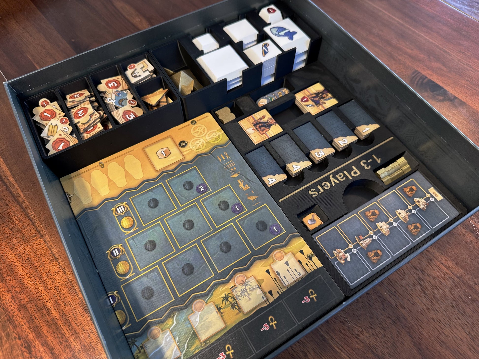 Men-Nefer board game organizer by KreativLayers, featuring custom compartments for game pieces and cards.