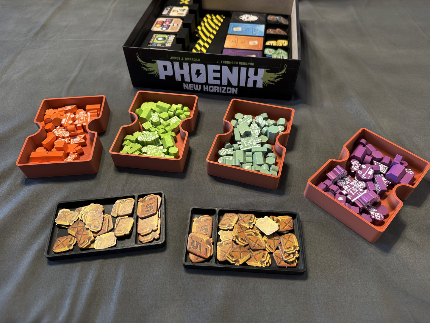 Phoenix New Horizon board game organizer by KreativLayers, showcasing compartments for game pieces and cards.