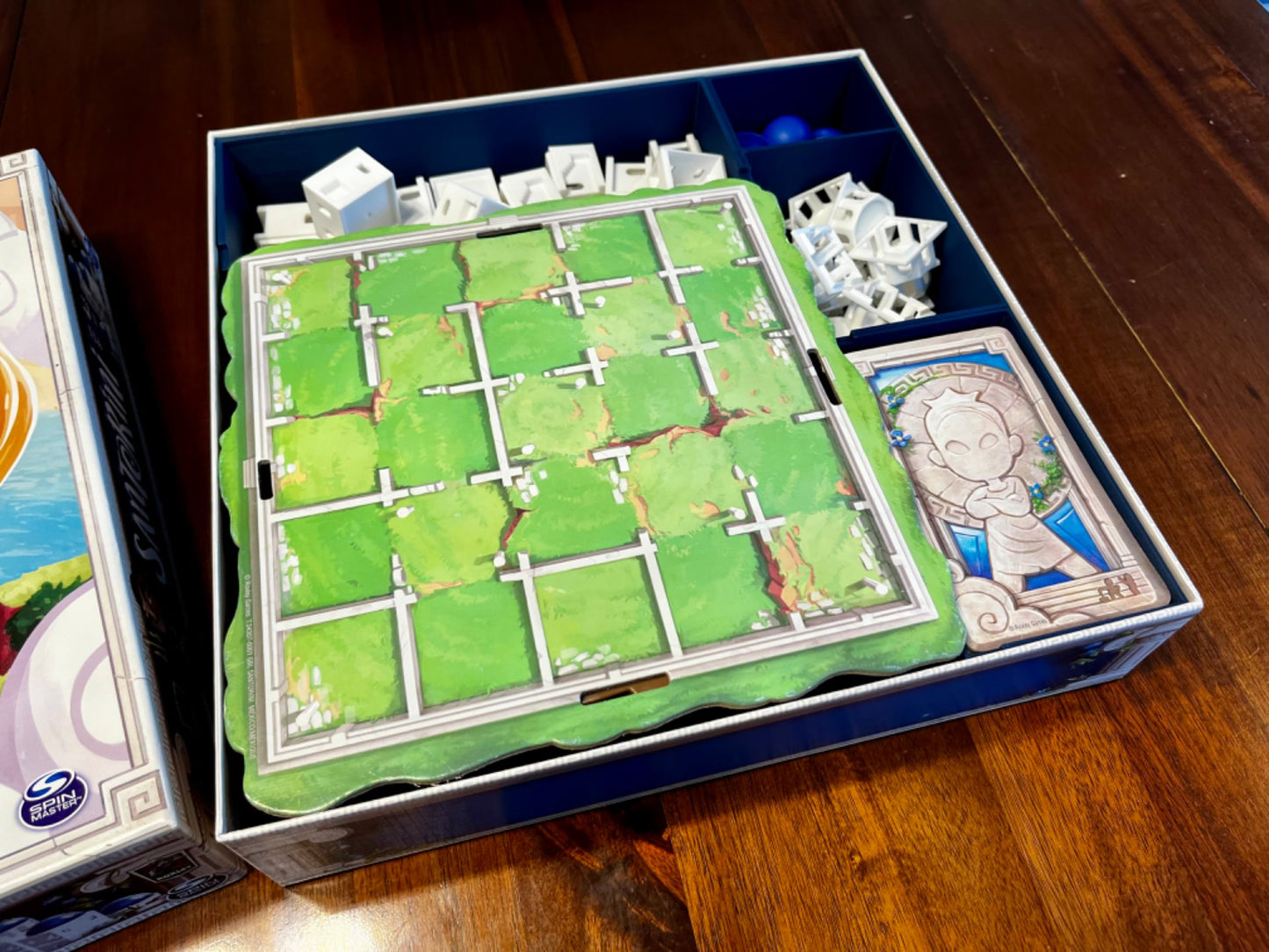 KreativLayers Santorini board game organizer, featuring compartments for game pieces and cards in a sturdy design.