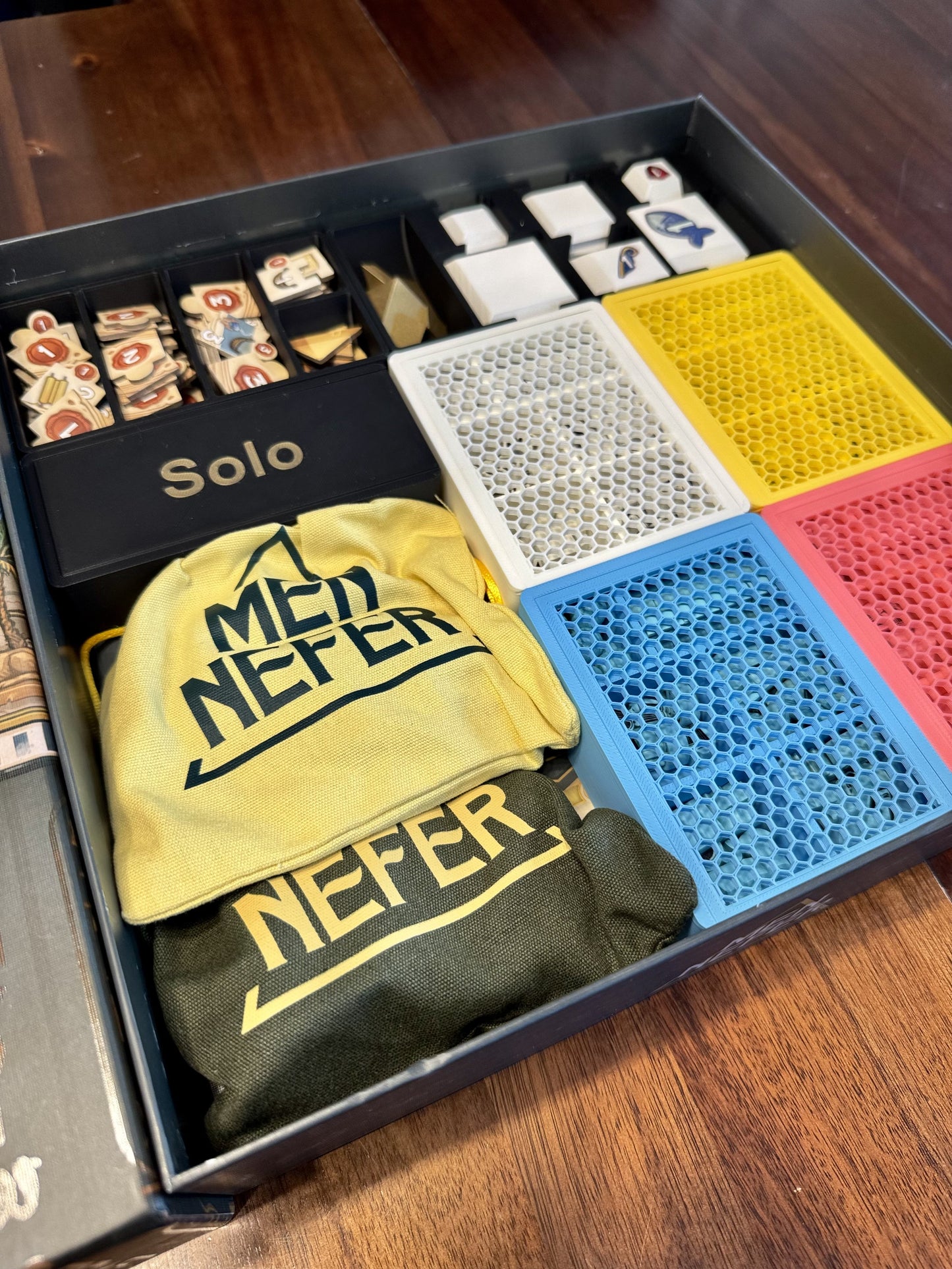Men-Nefer Board Game Organizer by KreativLayers, featuring compartments for game pieces and cards in a sleek design.