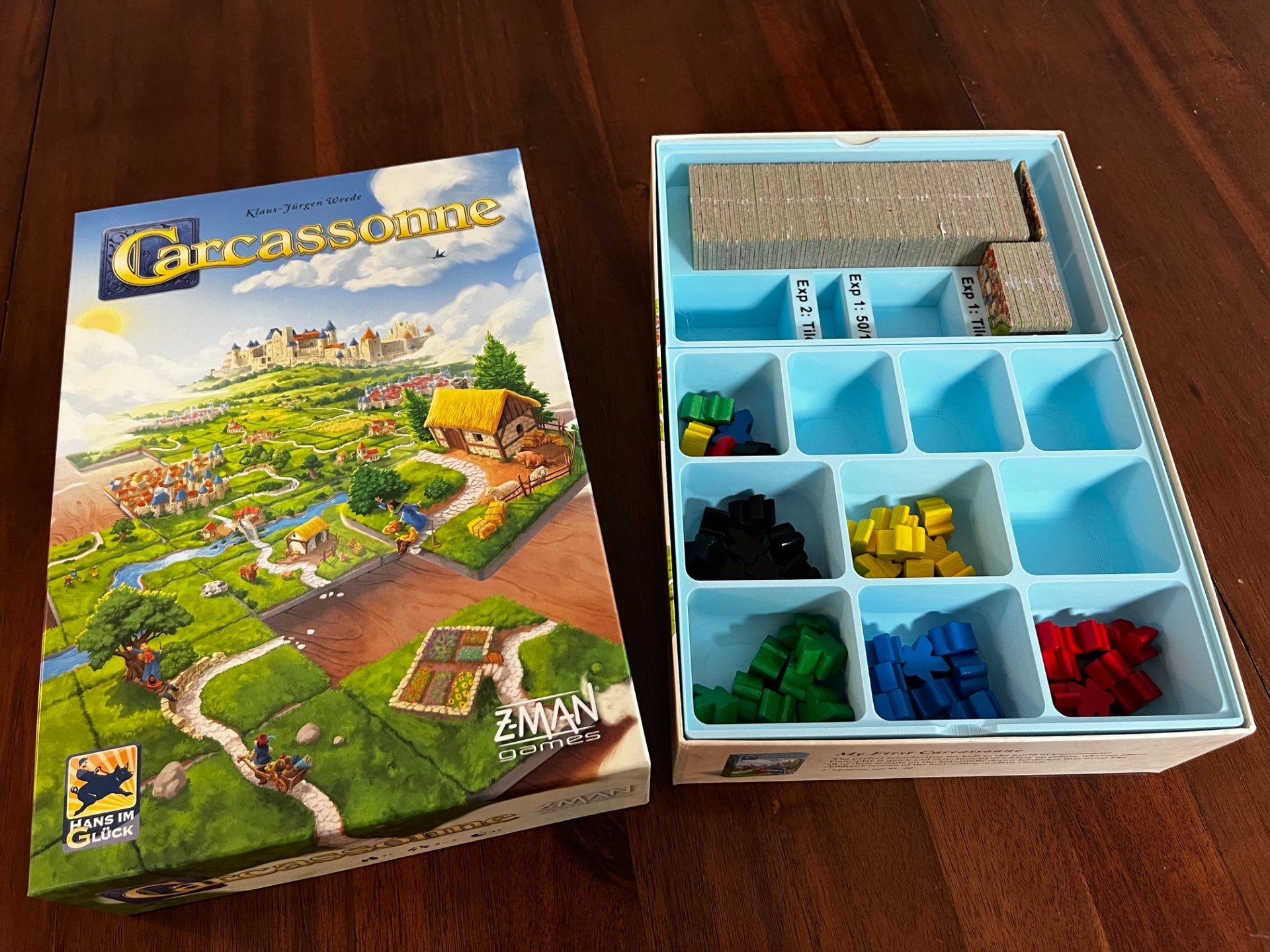 Carcassonne game insert by KreativLayers, featuring compartments for tiles and pieces in a well-organized design.