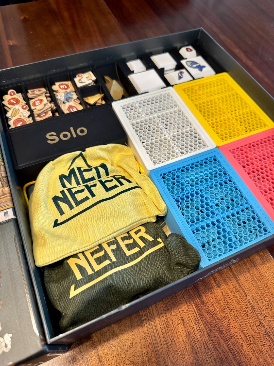 Men-Nefer board game organizer by KreativLayers, featuring compartments for game pieces and cards in a sturdy design.
