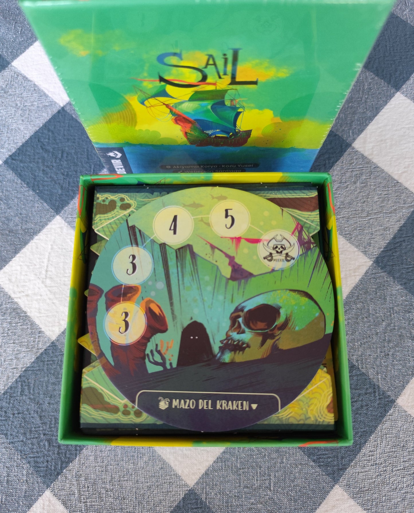 KreativLayers Sail INSERT board game organizer with compartments for game pieces and cards, displayed on a wooden table.