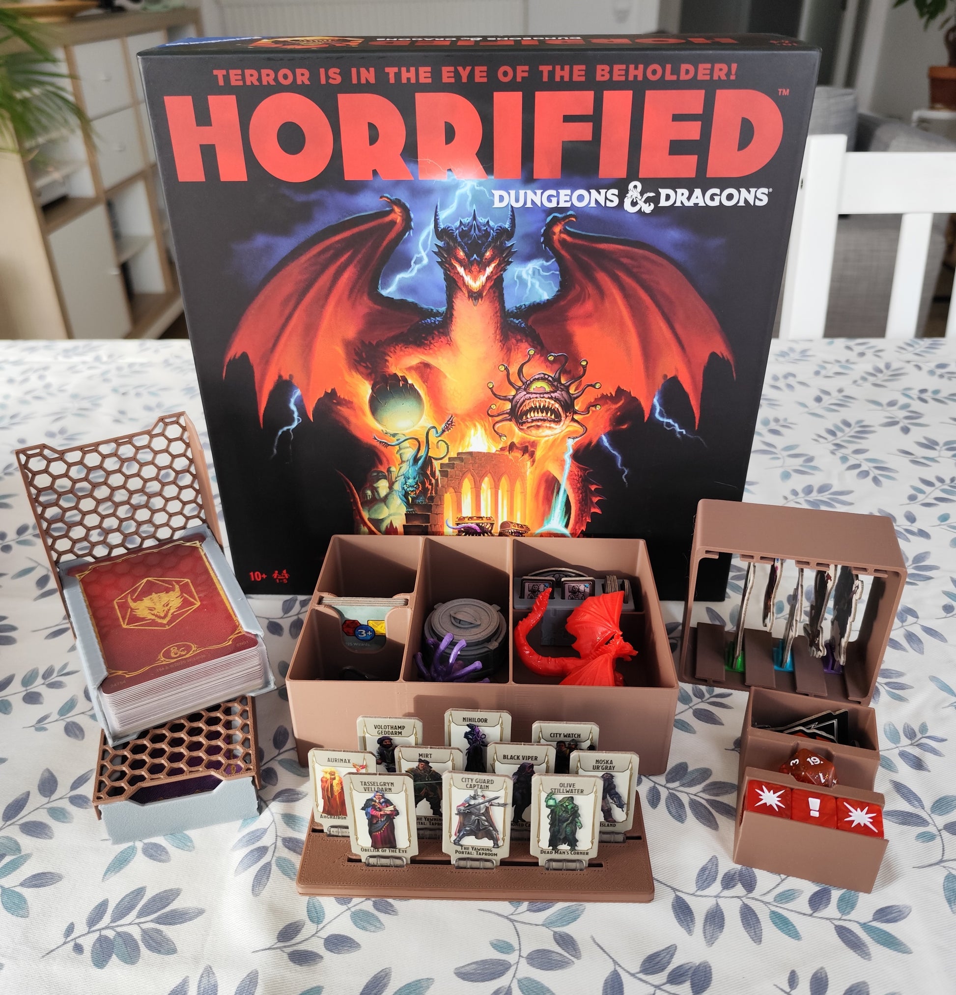 Board game organizer for Horrified Dungeons & Dragons by KreativLayers, featuring compartments for game pieces and cards.
