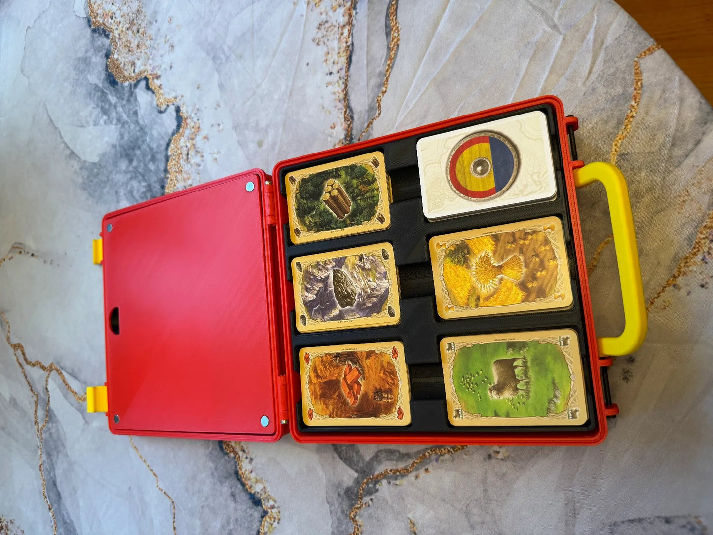 KreativLayers Catan Base Board Game Organizer box for USA version, with compartments for game pieces and cards on a wooden surface.