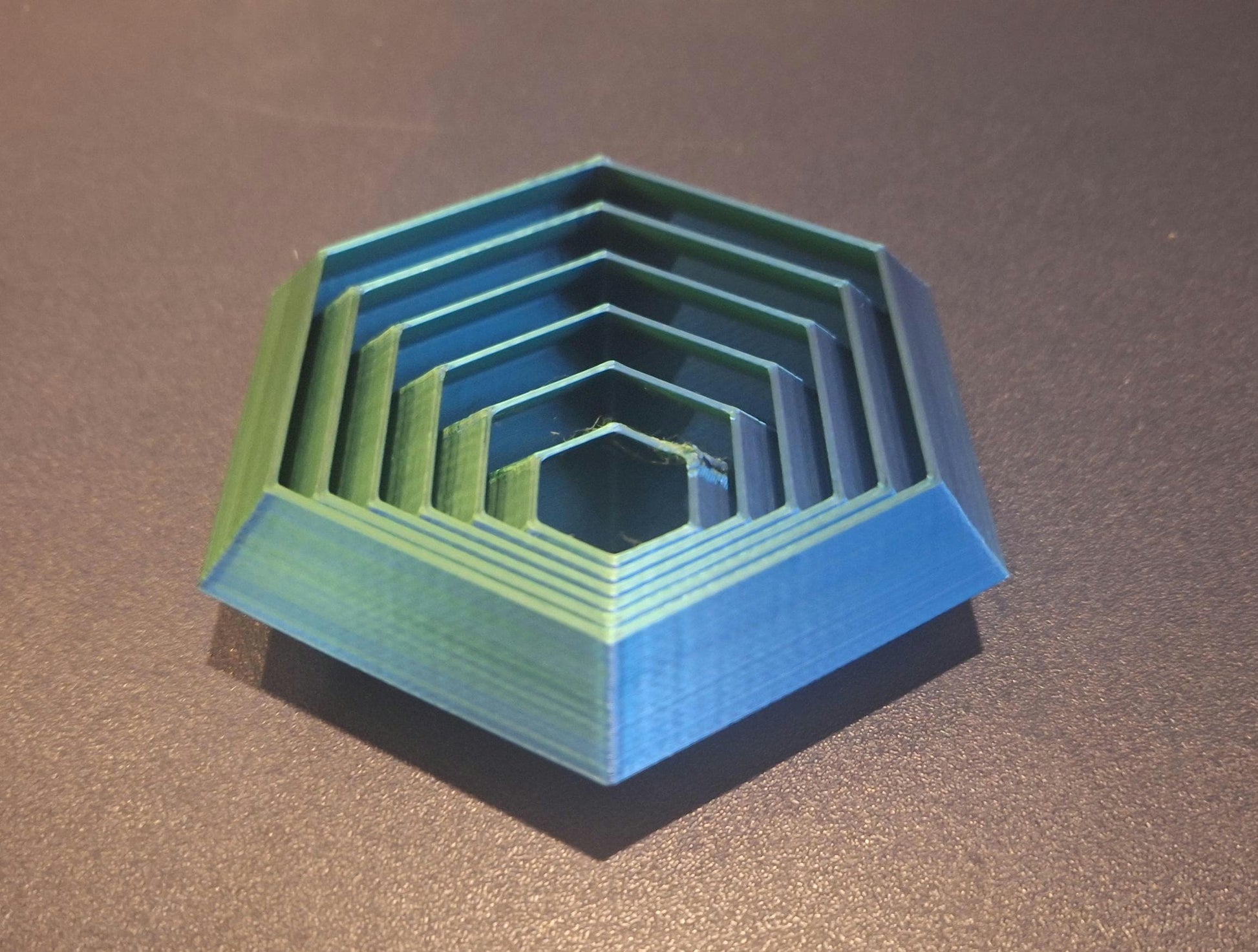 KreativLayers 3D printed hexagonal board game organizer insert on a dark surface
