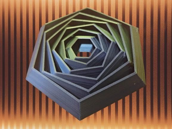 Hexagonal 3D printed board game organizer insert displayed on striped background