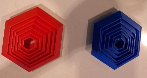 Red and blue hexagonal 3D printed board game organizers from KreativLayers