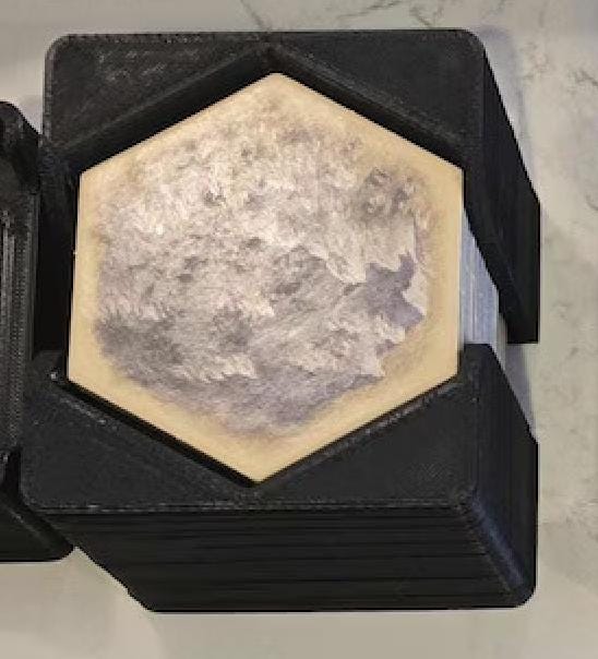 Hexagonal 3D printed board game organizer from KreativLayers on marble surface