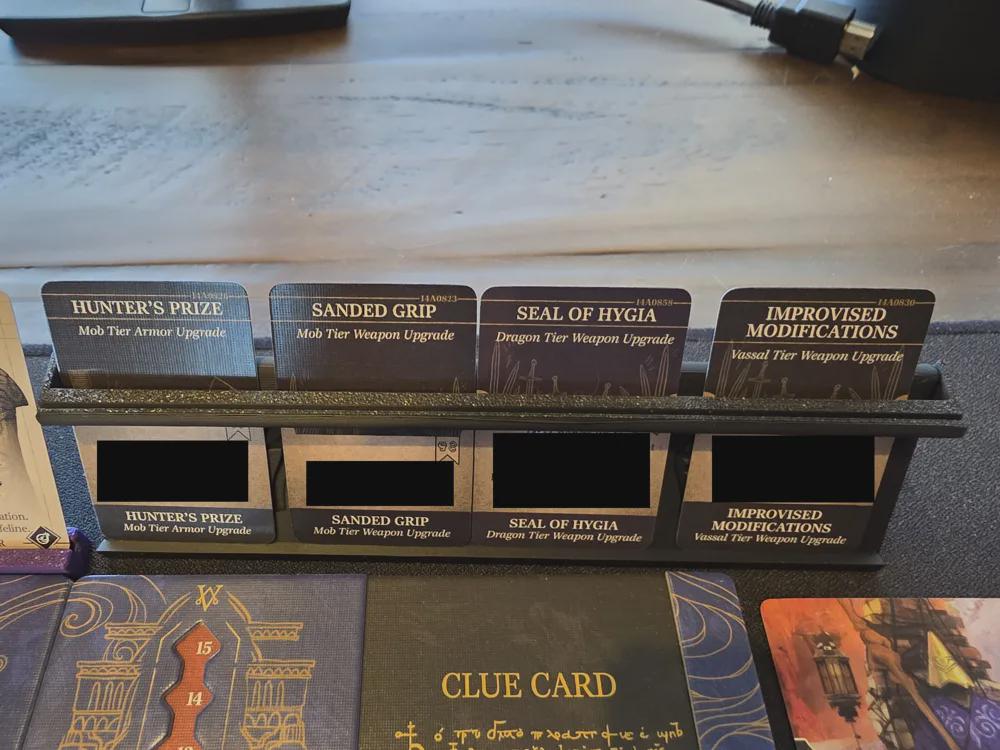 3D printed board game card organizer holding various upgrade cards, featured on a tabletop