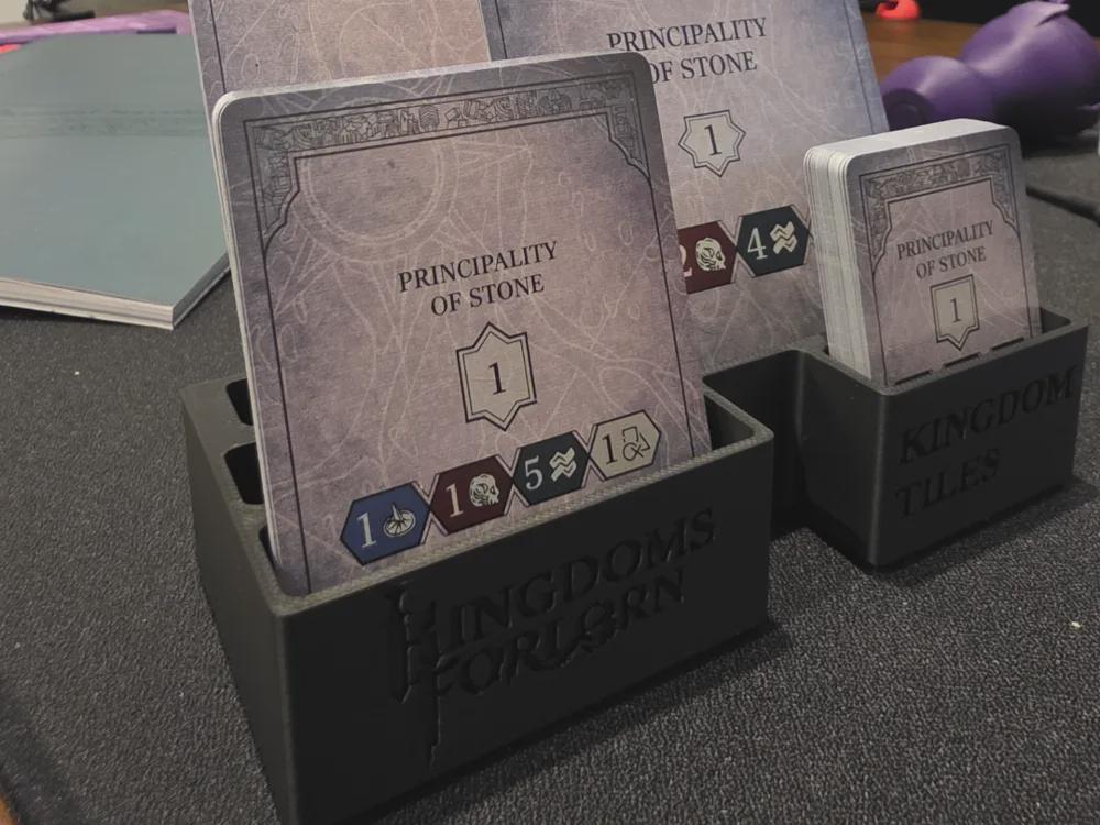 3D printed board game organizer holding Kingdoms Forlorn cards and kingdom tiles on table