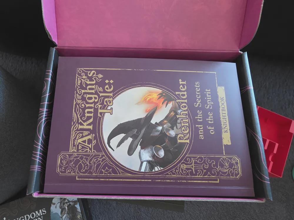 Board game box with 'A Knight's Tale: Renholder and the Secrets of the Spirit' rulebook inside, tabletop game storage solution.
