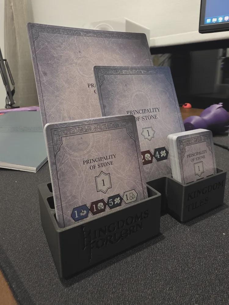 3D printed Kingdoms Forlorn board game card and tile organizer holding game cards on desk.