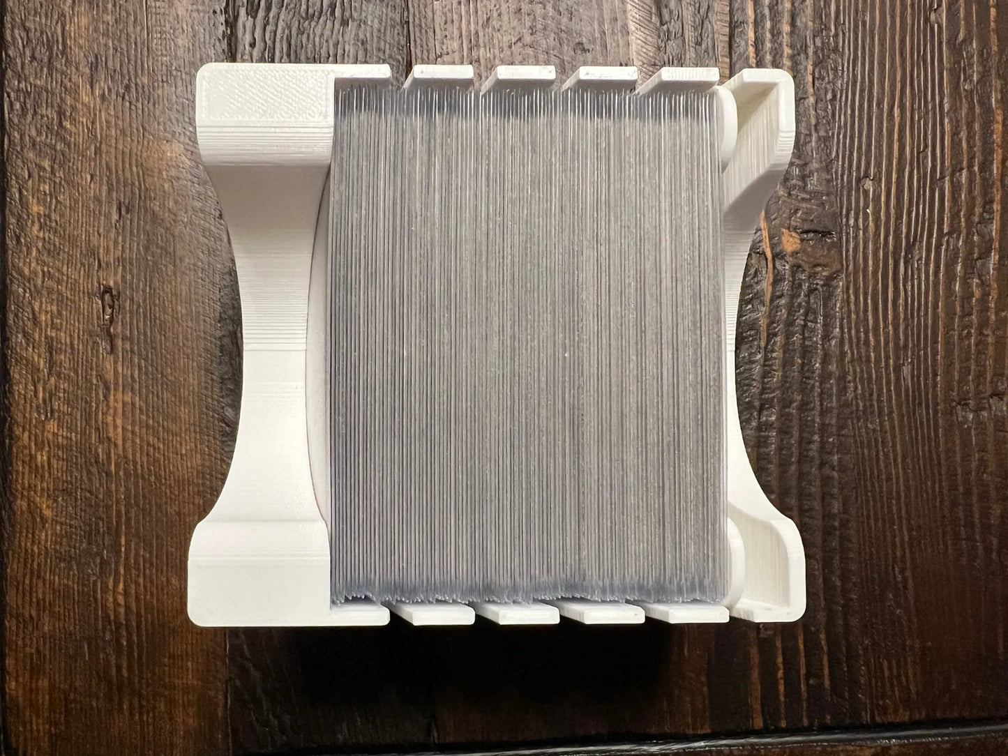 3D printed board game card organizer with cards, tabletop storage solution on wood table