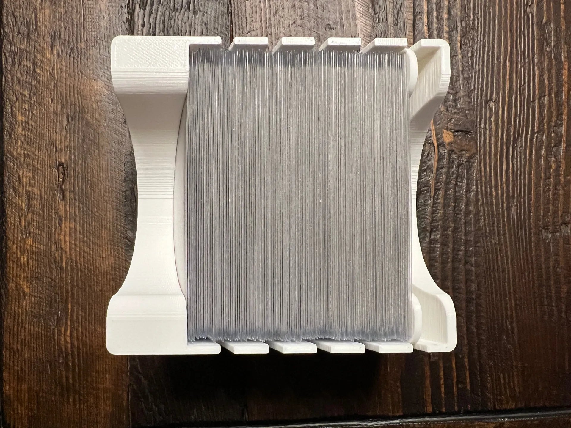 3D printed board game card organizer with cards, tabletop storage solution on wood table