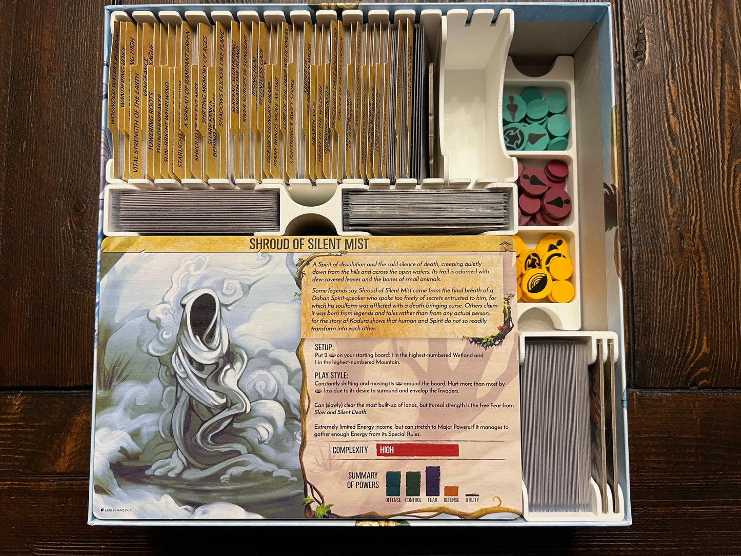 Board game organizer with labeled card slots, colorful tokens, and a printed Shroud of Silent Mist instruction card, neatly stored in a game box insert by KreativLayers.