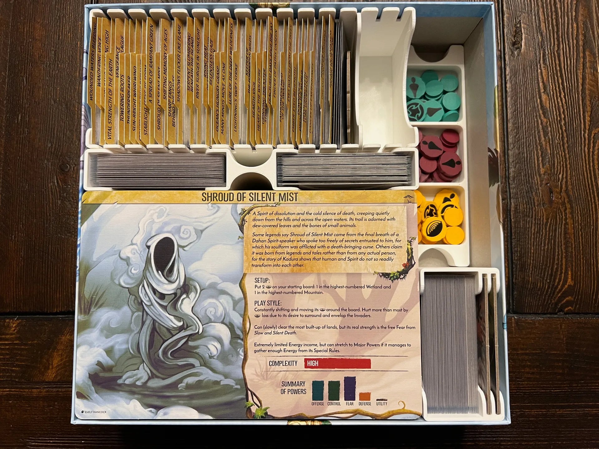 Board game organizer with labeled card slots, colorful tokens, and a printed Shroud of Silent Mist instruction card, neatly stored in a game box insert by KreativLayers.