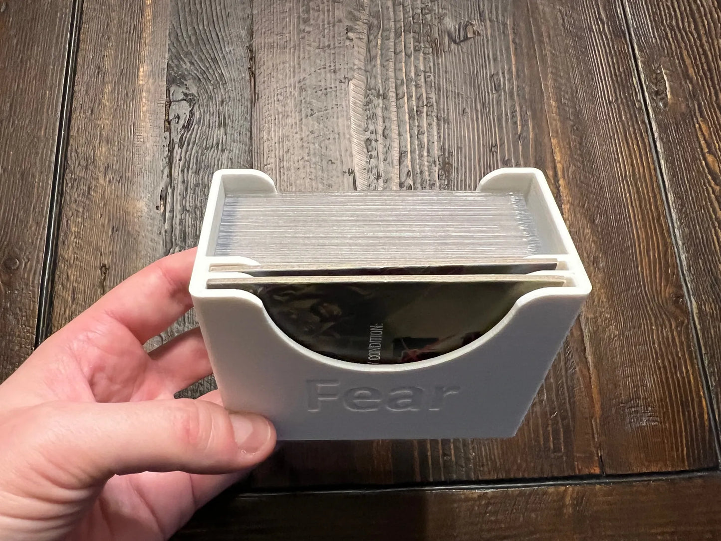 3D printed board game card organizer labeled 'Fear' on wooden table, KreativLayers storage solution