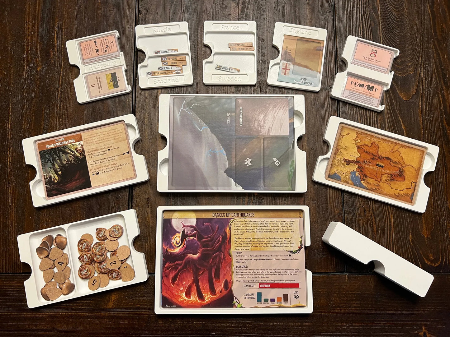 KreativLayers 3D printed board game organizer trays with cards and tokens neatly arranged on a wooden table.
